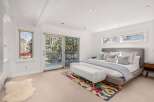 Step into a serene bedroom retreat, bathed in natural light and offering stunning views.