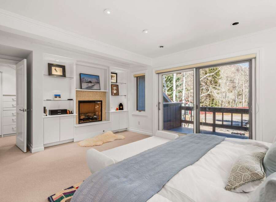 This stunning bedroom boasts a cozy fireplace, perfect for chilly evenings.