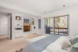 This stunning bedroom boasts a cozy fireplace, perfect for chilly evenings.