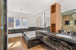 Indulge in luxury within this stunning bathroom, featuring exquisite black marble countertops and a sleek, modern design.