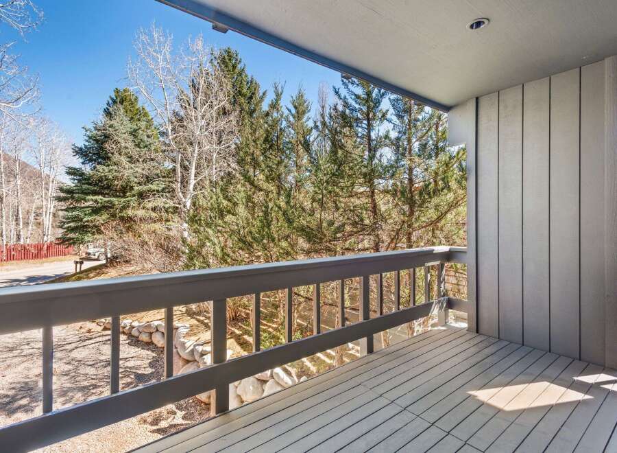 Enjoy breathtaking views from this stunning balcony overlooking a lush landscape.