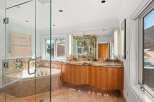 Step into luxury with this stunning bathroom featuring a spacious walk-in shower and a relaxing soaking tub.