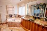 Step into luxury with this stunning bathroom! Featuring a beautiful bathtub, a curved vanity with dual sinks, and a gorgeous marble countertop, this space is designed for relaxation and style.