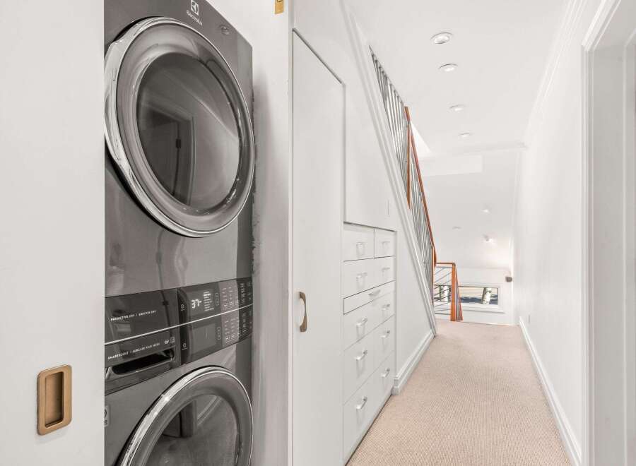 Discover the epitome of modern living with this stunning property, showcasing a sleek and efficient Electrolux washer and dryer set.