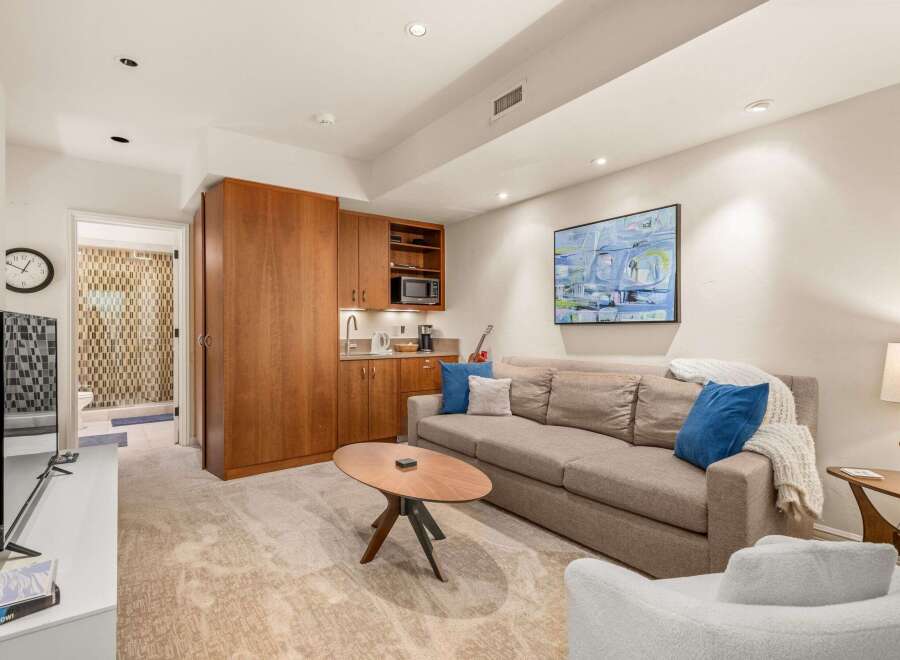 Discover modern living in this stylish property, featuring a cozy living area with a comfortable sofa and a unique coffee table.