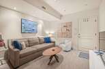 Step into this inviting living space, featuring a cozy sofa adorned with plush pillows, perfect for relaxation.