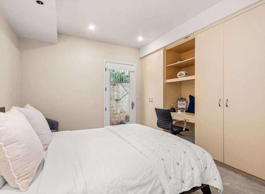 This bedroom offers a blend of comfort and functionality, perfect for relaxation and productivity.