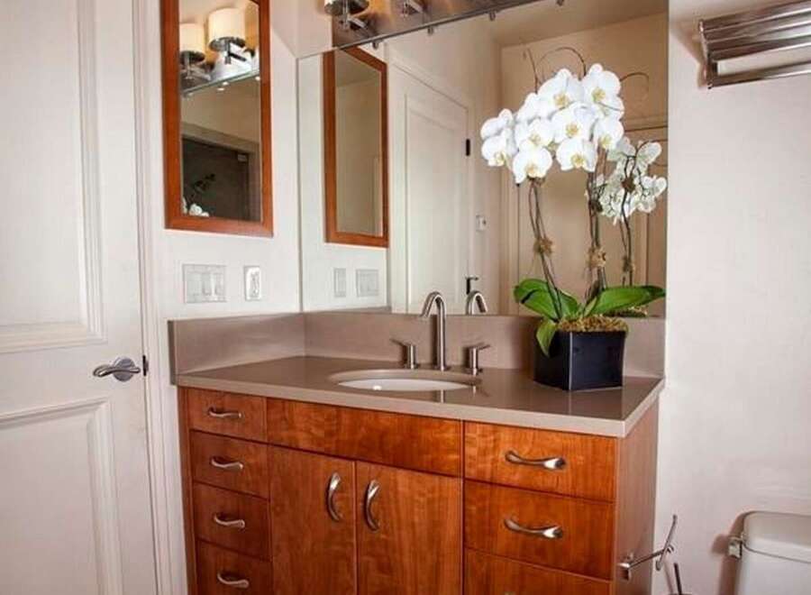 This stunning bathroom features a beautiful wooden vanity with ample storage, perfect for keeping your essentials organized.