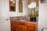 This stunning bathroom features a beautiful wooden vanity with ample storage, perfect for keeping your essentials organized.