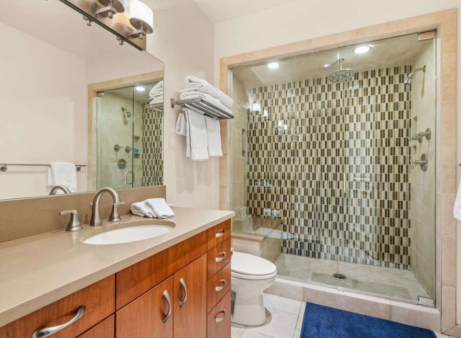 Step into luxury with this stunning bathroom! Featuring a spacious walk-in shower with a unique tile design, this bathroom offers a spa-like experience.