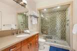 Step into luxury with this stunning bathroom! Featuring a spacious walk-in shower with a unique tile design, this bathroom offers a spa-like experience.