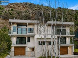 This stunning modern home offers a luxurious living experience with its sleek design and high-end finishes.