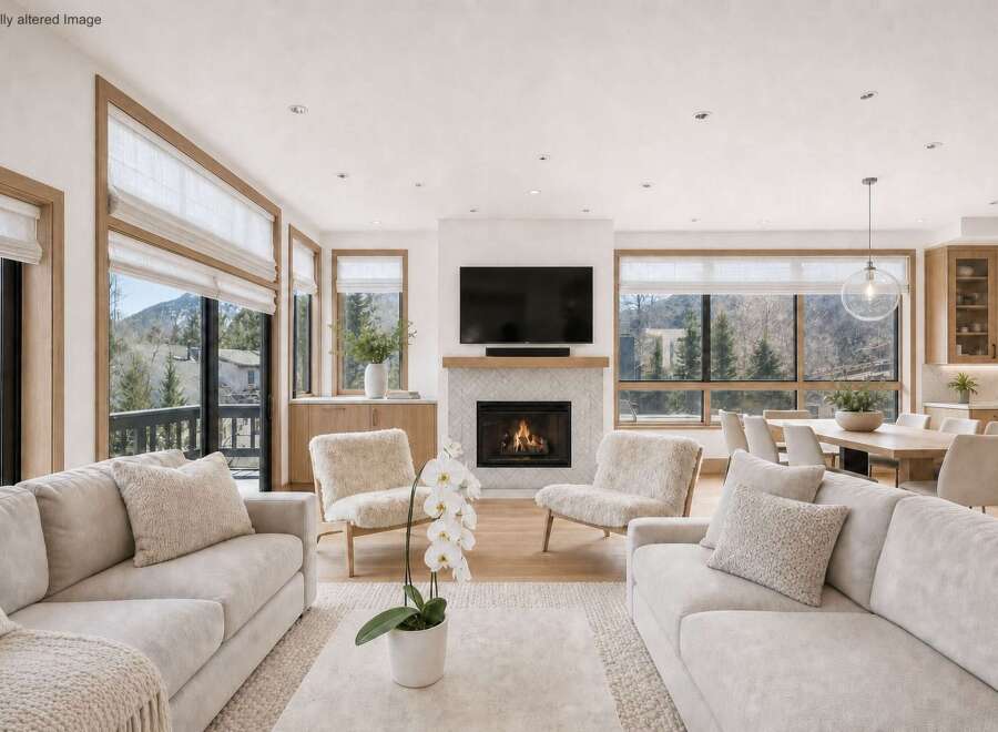 Experience luxury living in this stunning property, featuring a cozy living room with a fireplace and comfortable seating.