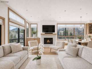 Experience luxury living in this stunning property, featuring a cozy living room with a fireplace and comfortable seating.