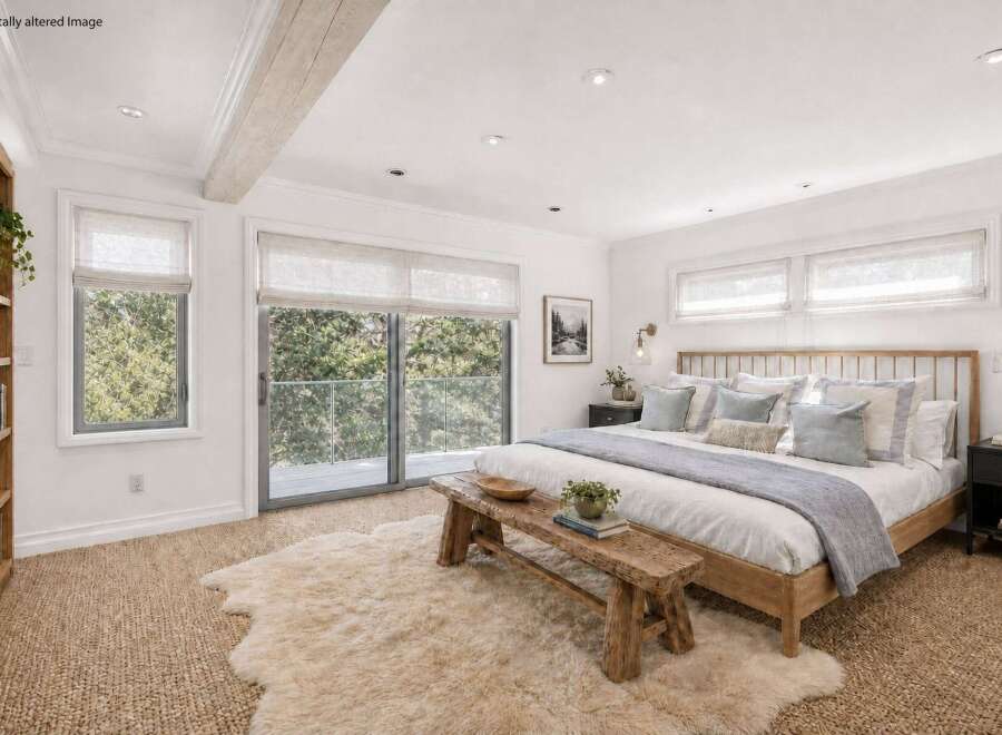 This stunning bedroom offers a serene retreat with its bright, airy design and natural light.