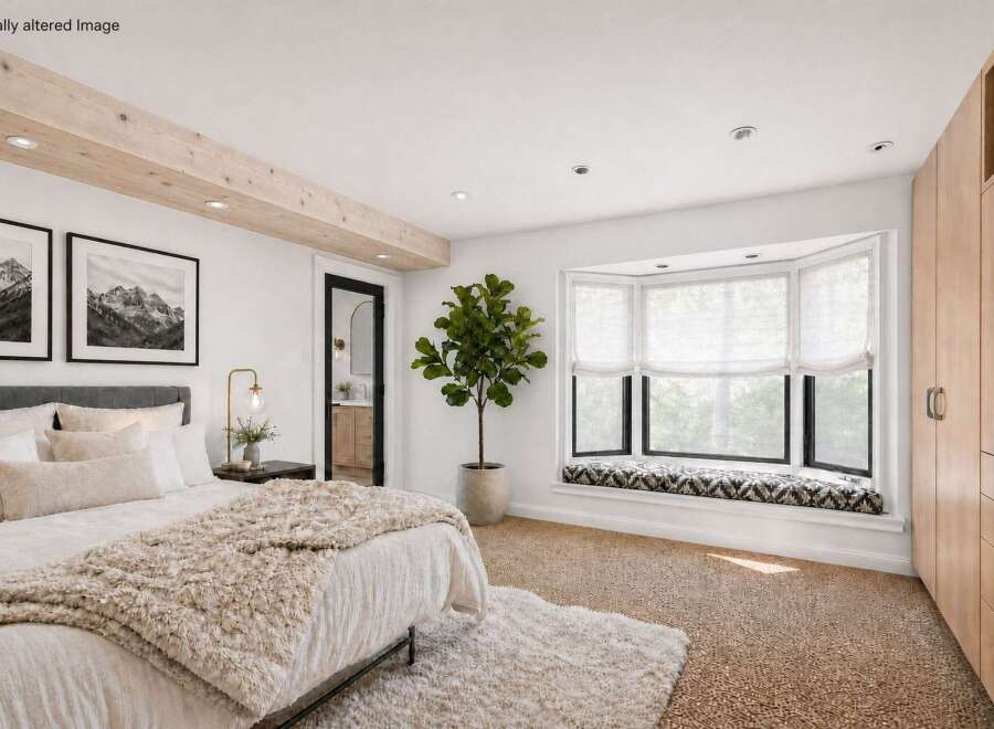 Step into luxury with this stunning bedroom, featuring a cozy bed adorned with plush pillows and a textured throw.