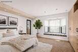 Step into luxury with this stunning bedroom, featuring a cozy bed adorned with plush pillows and a textured throw.