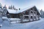Experience the charm of a cozy log cabin nestled in a winter wonderland.