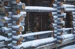 This charming log cabin exudes rustic elegance, perfect for a cozy winter retreat.