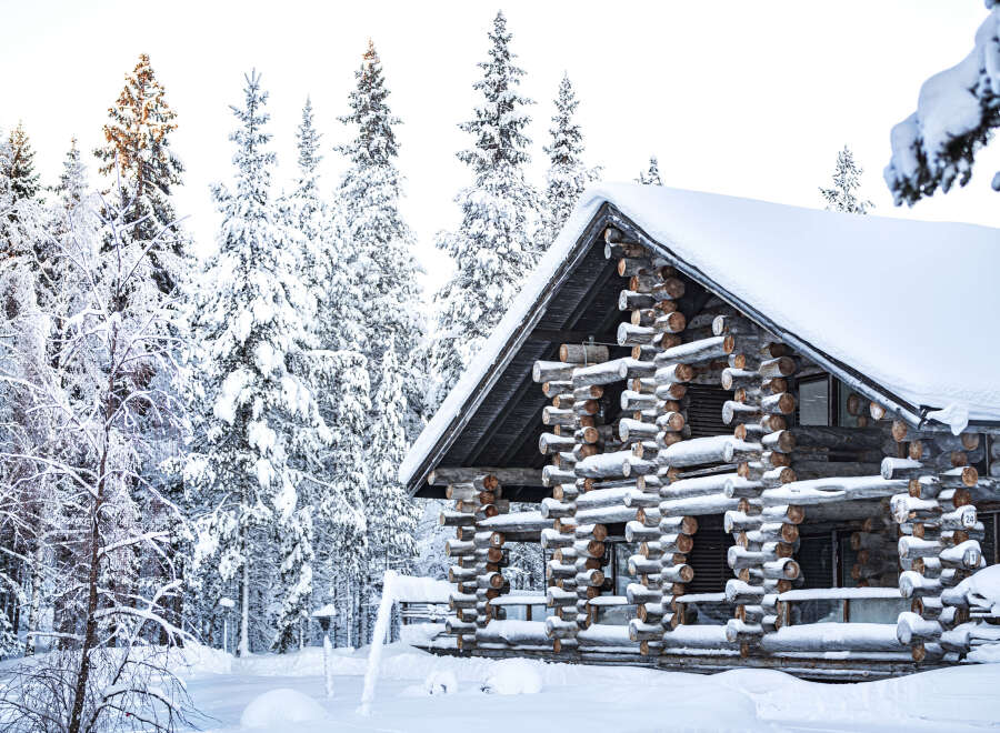 This stunning log cabin offers a serene escape in a winter wonderland.