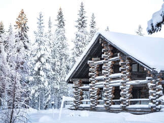 This stunning log cabin offers a serene escape in a winter wonderland.