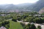 Discover a stunning property nestled in a picturesque valley, offering breathtaking views of the surrounding mountains and a charming town.