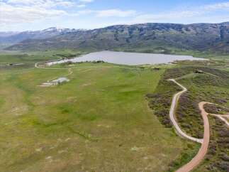 Discover the tranquility of this stunning property, offering breathtaking views of a serene lake and majestic mountains.