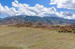 Discover the tranquility of this stunning property, nestled amidst breathtaking mountain views and expansive fields.
