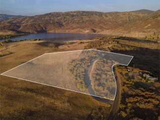 Discover the perfect canvas for your dream home or investment opportunity! This expansive property offers breathtaking views of a serene lake and rolling hills, providing a tranquil escape.