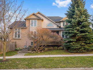 This stunning two-story home boasts a beautiful brick facade and a well-manicured lawn, offering excellent curb appeal.