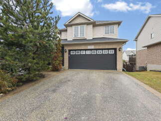 This stunning two-story home boasts a charming exterior and a spacious driveway.