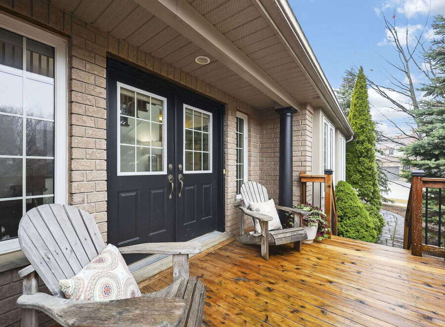 Welcome to your dream home! This stunning property boasts a beautiful front porch with inviting Adirondack chairs, perfect for relaxing.
