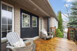 Welcome to your dream home! This stunning property boasts a beautiful front porch with inviting Adirondack chairs, perfect for relaxing.
