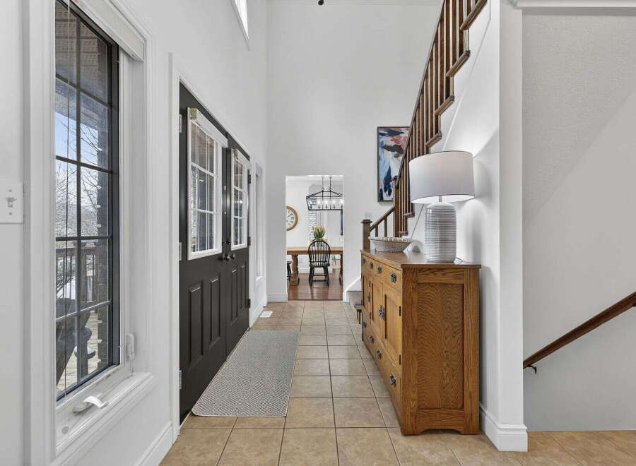 Step into this inviting entryway, showcasing a blend of classic and contemporary design.