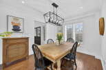 This stunning dining room features a beautiful wooden table and chairs, perfect for hosting family gatherings.