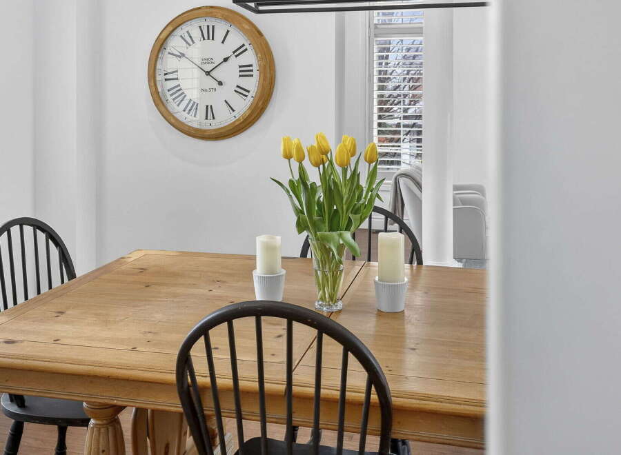 This charming dining room features a beautiful wooden table, perfect for family gatherings.