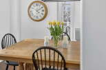 This charming dining room features a beautiful wooden table, perfect for family gatherings.