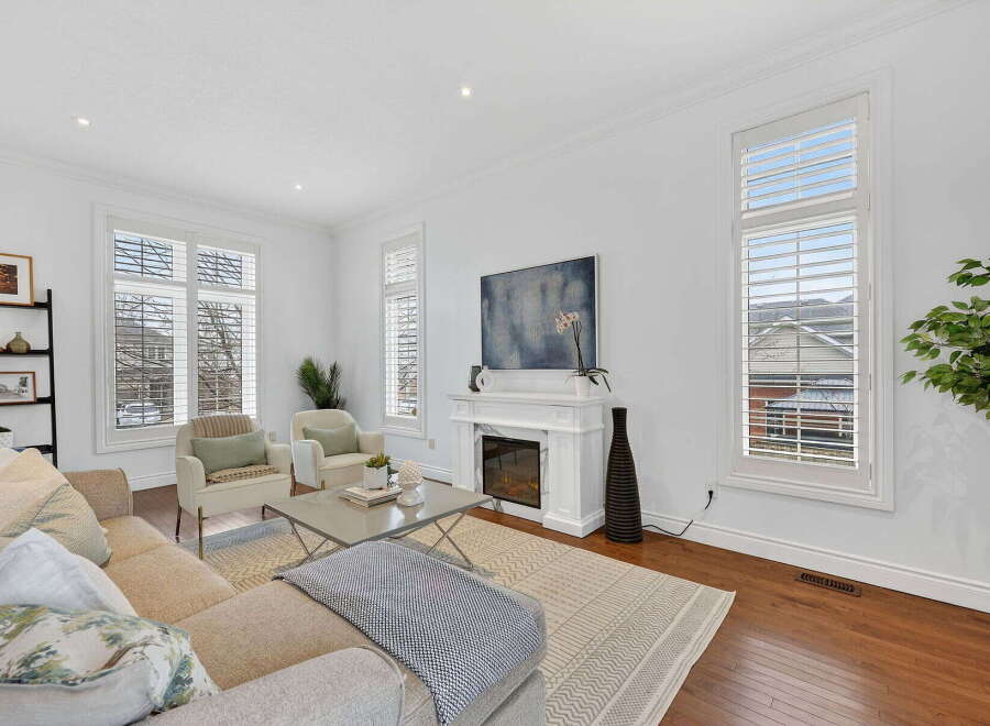 Step into luxury with this stunning living room, featuring a cozy fireplace and elegant design.