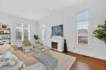 Step into luxury with this stunning living room, featuring a cozy fireplace and elegant design.
