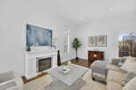 This stunning living room boasts a modern fireplace, perfect for cozy evenings.