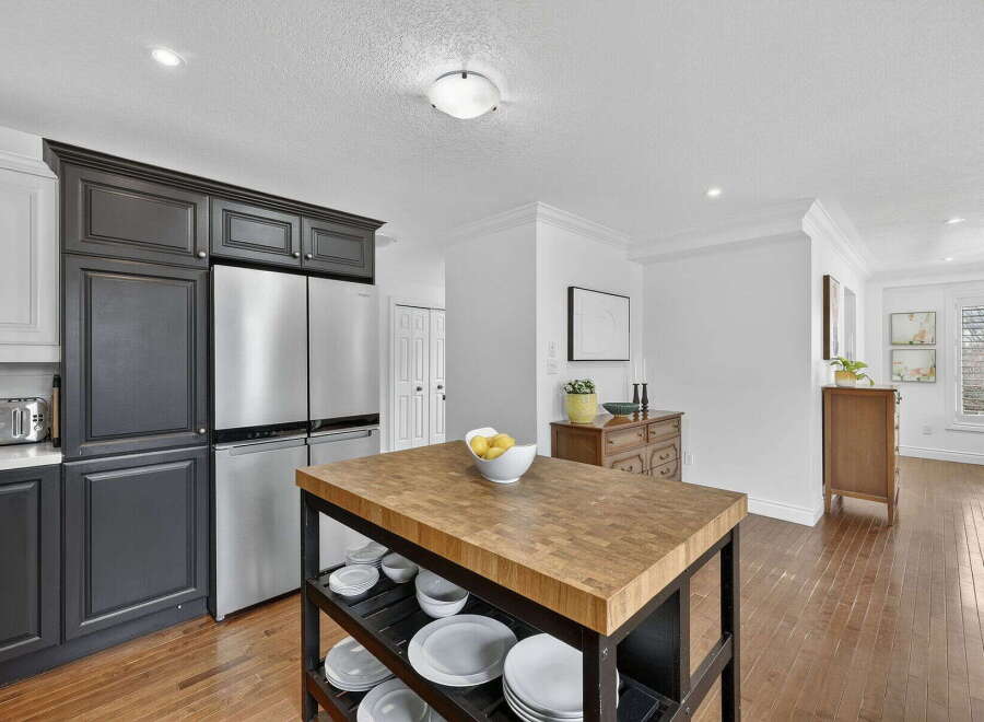 This stunning kitchen boasts a modern design with sleek stainless steel appliances and dark cabinetry.
