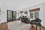 Step into this elegant home office, bathed in natural light from the large windows.