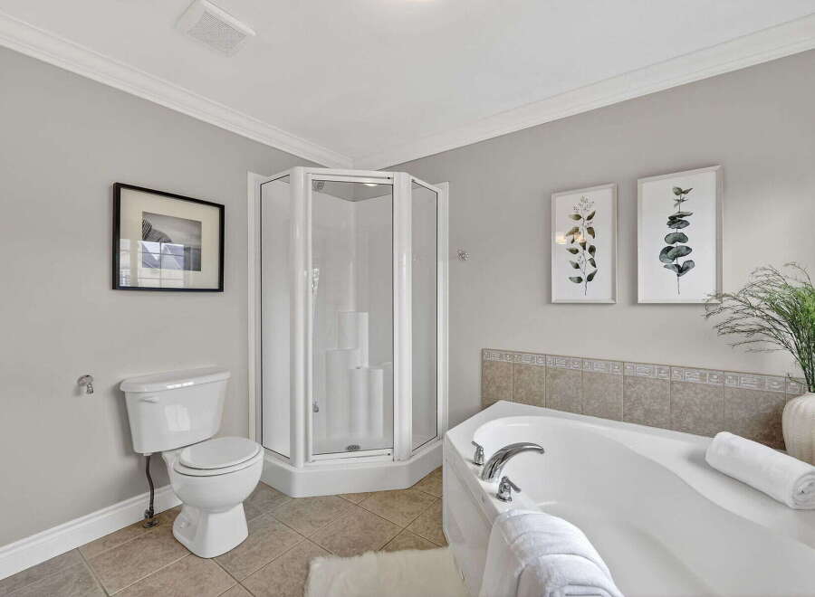 Step into a serene bathroom retreat, featuring a modern shower and a luxurious soaking tub.