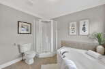Step into a serene bathroom retreat, featuring a modern shower and a luxurious soaking tub.
