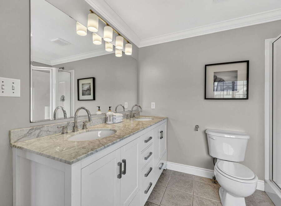 Step into luxury with this beautifully designed bathroom! Featuring a double vanity with a stunning marble countertop, this space offers both style and functionality.