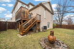 Enjoy outdoor living at its finest with this stunning property featuring a spacious wooden deck and a cozy fire pit.
