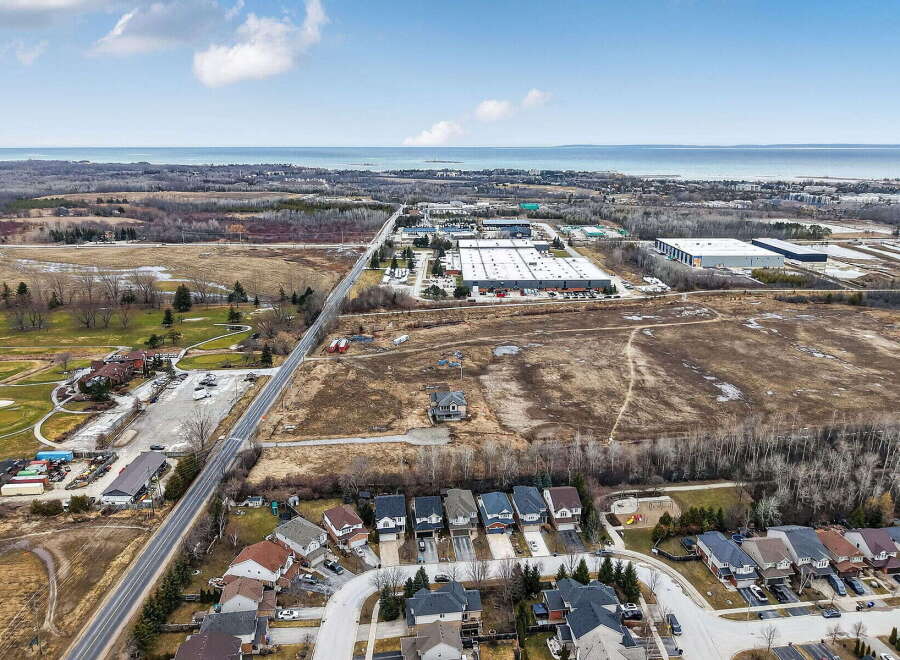 Discover the perfect blend of suburban tranquility and industrial convenience in this stunning aerial view.