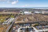 Discover the perfect blend of suburban tranquility and industrial convenience in this stunning aerial view.