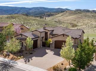 This stunning property boasts a beautiful exterior with a tile roof and a spacious driveway.