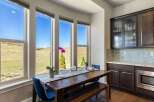 This stunning dining area boasts expansive windows that frame breathtaking views of the surrounding landscape.